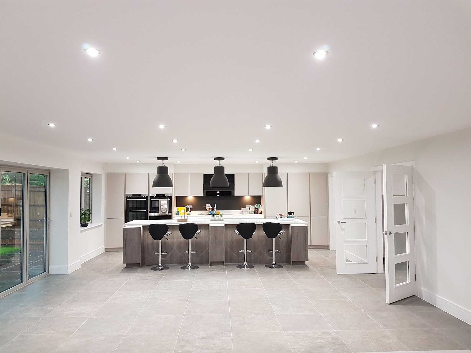 Open-plan Southampton kitchen with recessed downlights and pendant lighting fitted throughout