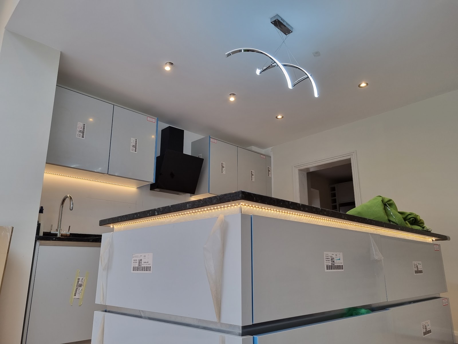 Kitchen with warm under-cabinet and island LED strip lighting fitted by TG Electrical